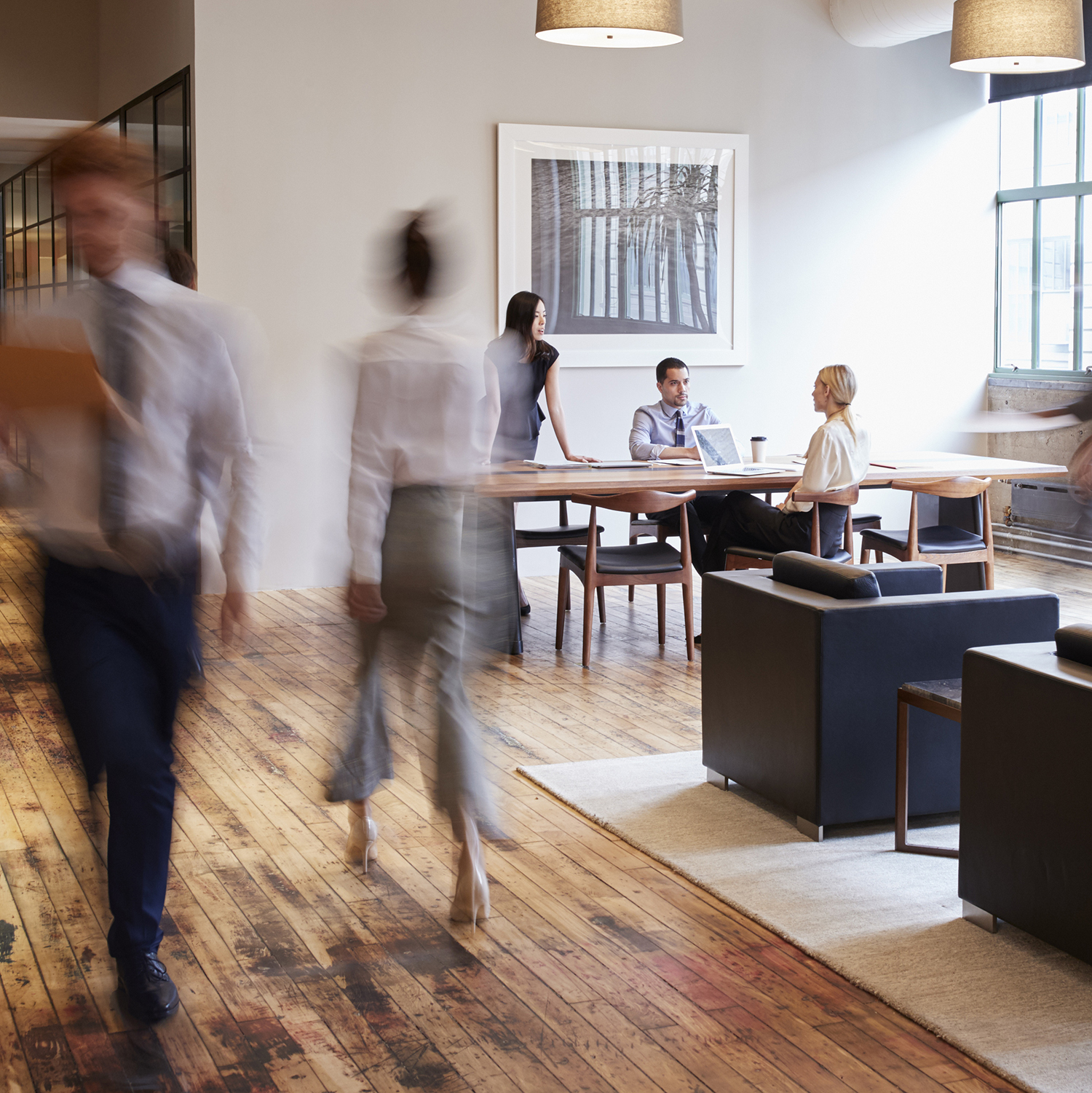 Business people at work in a busy luxury office space